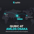 The image shows a promotional graphic titled "QUBIC AT AMLDS OSAKA" featuring a world map with flight paths connecting global tech hubs like Silicon Valley and Kyoto, alongside an event poster highlighting Qubic's presence at the AMLDS conference in Osaka, Japan.