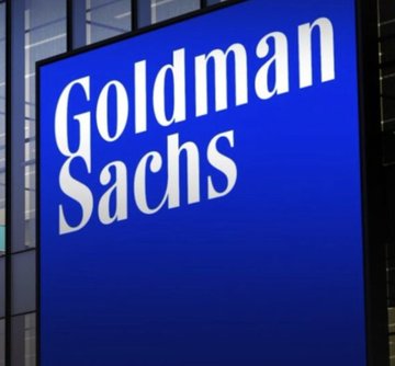 A blue Goldman Sachs sign is displayed outside a building, as the post announces that the major investment bank has reportedly acquired a $1 billion Bitcoin ETF amid surging client demand for BTC products.