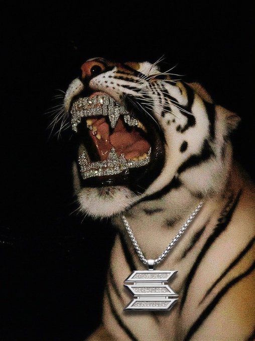 A tiger snarls menacingly against a black background, wearing a diamond-encrusted grill over its teeth and a silver chain necklace with a geometric pendant.