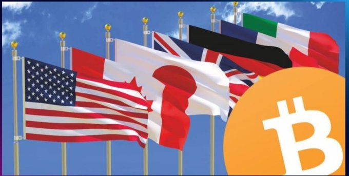 A row of national flags including those of the United States, Canada, Japan, the United Kingdom, and Italy waves against a blue sky, overlaid with a large orange Bitcoin (₿) logo.