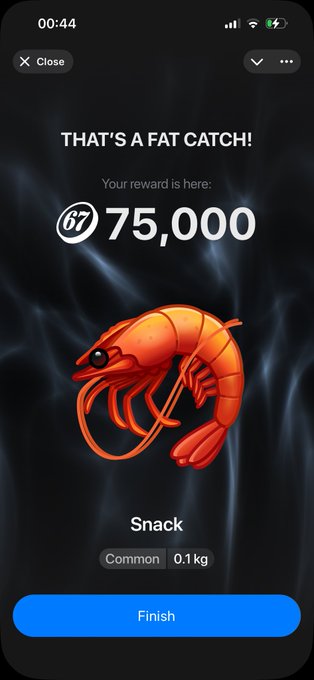 A mobile app screen displays a reward of 75,000 points for catching a 'Snack' (Common, 0.1 kg), illustrated by a cartoon shrimp, with a 'Finish' button at the bottom.