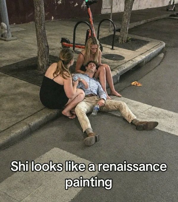 Three young people rest on a curb at night near a crosswalk, with one person lying on the ground while two women sit nearby; the caption reads 'Shi looks like a renaissance painting'.