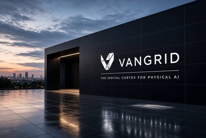 A sleek black building exterior at sunset with the VANGRID logo and the tagline 'THE SPATIAL CORTEX FOR PHYSICAL AI' displayed on its dark facade.