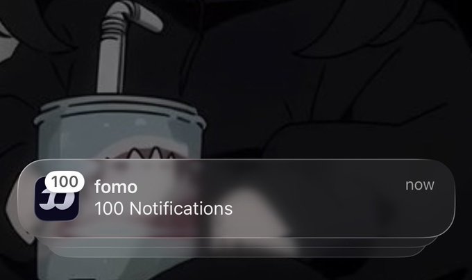 A notification overlay on an iPhone screen shows "fomo" with "100 Notifications" alongside the now timestamp, visually representing the overwhelming flood of FOMO alerts being referenced in the post.