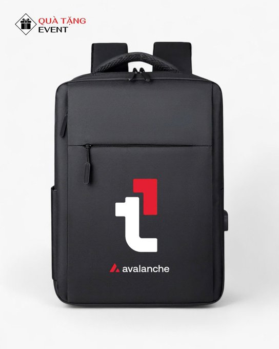 A black backpack featuring a red and white Avalanche (AVAX) logo and the 'avalanche' brand name, labeled as a 'QUÀ TẶNG EVENT' (Gift Event) item.