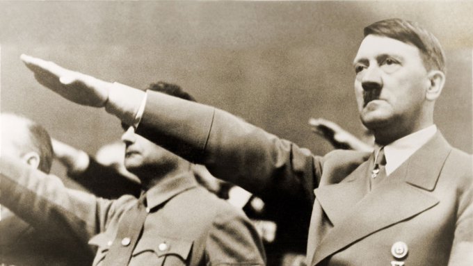 The image shows two men dressed in military uniforms standing next to each other with their arms raised high above their heads. The man on the left has his arm extended, while the man on the right also raises his hand. They appear to be posing for a picture or participating in an event. In the background, there are several people present, but they are not as prominent as the two main subjects. The image does not provide any information about Bitcoin or cryptocurrency, and it seems unrelated to the post that says "The privacy coin narrative will end, and eventually, $ZEC and 
XMR will drop 99% against Bitcoin".
