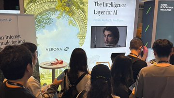 A crowd of people gathered at what appears to be a trade show or convention, watching a presentation about 'The Intelligence Layer for AI' by a private AI company, with a Verona booth visible.