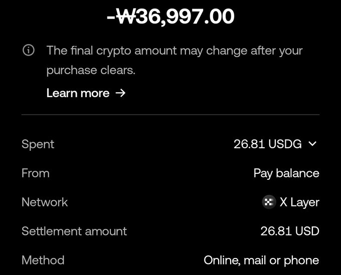 A dark-themed transaction confirmation screen with '-₩36,997.00' crossed out at the top, showing details including Spent 26.81 USDG, Pay balance, X Layer network, Settlement amount of 26.81 USD, and Online, mail or phone method.