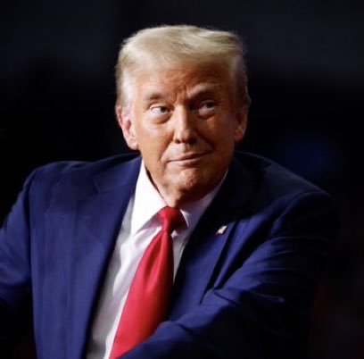 A man in a dark suit and red tie, resembling Donald Trump, looks off to the side.