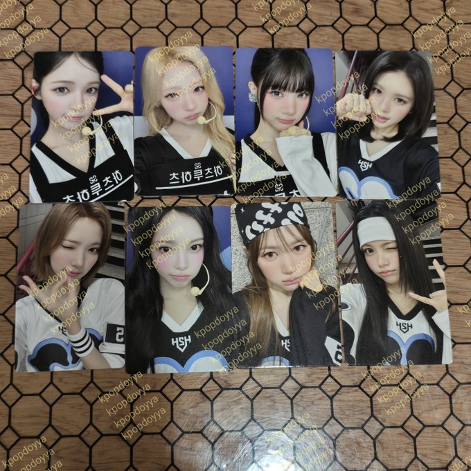 Eight Hearts2Hearts Jump Up photocard merchandise featuring members Carmen, Stella, Yuha, Jiwoo, Juun, Ana, Ian, and Yeon are arranged on a hexagonal patterned surface, with each photocard watermarked by "kpopdoyya."