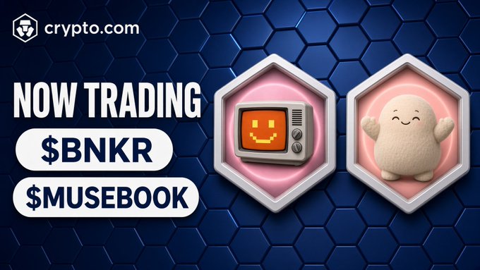 A promotional graphic for 'crypto.com' announces 'NOW TRADING $BNKR' and '$MUSEBOOK' alongside cartoon 3D icons of a TV and a white blob character.