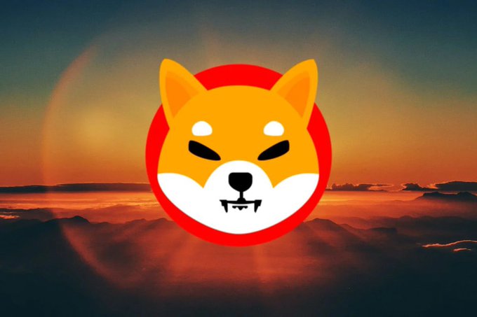 A Shiba Inu dog face logo within a red circle set against a warm, orange sunset sky with clouds.