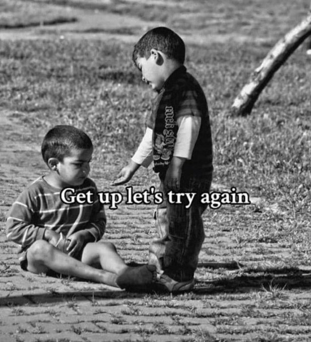 A black-and-white motivational image showing a standing child reaching a hand down to a seated child, overlaid with the text 'Get up let's try again'.
