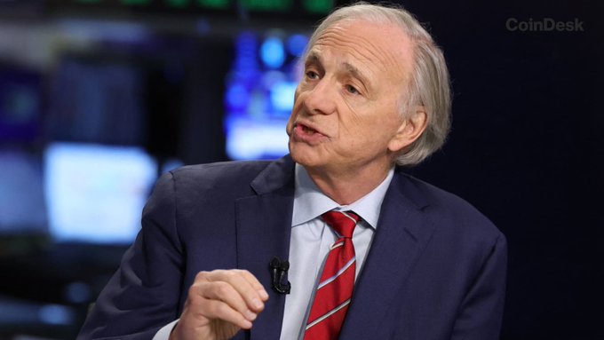 Ray Dalio, founder of Bridgewater Associates, speaks during a CoinDesk interview, appearing in a dark suit with a red striped tie. The "CoinDesk" watermark is visible in the upper right corner, tying the image to his recommendation that investors hold "a bit of Bitcoin" amid looming U.S. debt concerns.