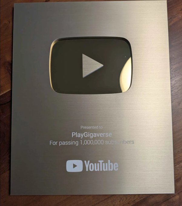 A silver YouTube Creator Award plaque presented to 'PlayGigaverse' for passing 1,000,000 subscribers, featuring the iconic play button logo.