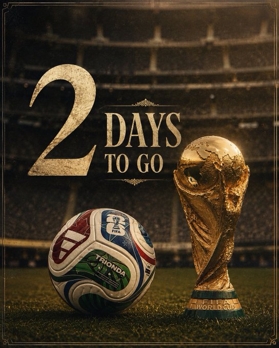 The image features a soccer ball with the number 2 written on it, placed next to a trophy that says "2 Days To Go" on it. The background of the image shows a stadium filled with people watching a soccer game.