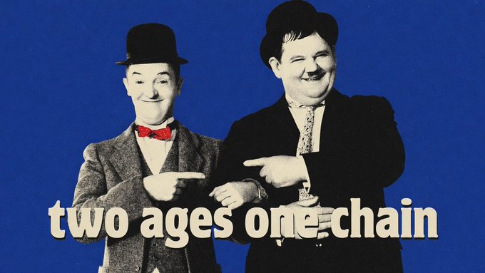 Black and white image of Stan Laurel and Oliver Hardy (Laurel and Hardy comedy duo) both wearing bowler hats and pointing at each other, with the text 'two ages one chain' overlaid in beige.