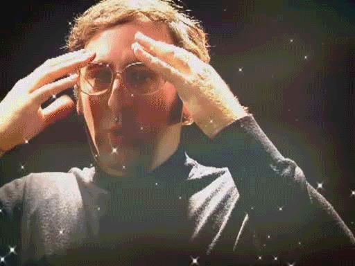 The image features a man wearing glasses and holding his head up high while looking at something off camera. The background of the image is dark, which contrasts with the bright stars visible behind him. There are also some stars scattered throughout the scene. The image does not provide any information about the content or context of the post that references this image.