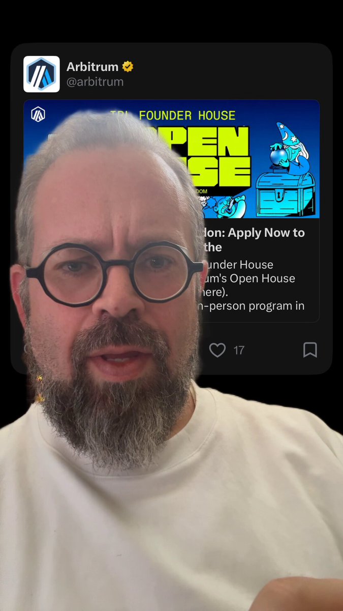 The image features an older man wearing glasses, who appears to be a participant of an open house event for a company named "Arbitrum". The man has a beard and is dressed in a white shirt. He is looking directly at the camera with a serious expression on his face. The background of the image shows a black screen displaying information about the open house event, including details such as the date, time, location, and the company's name.