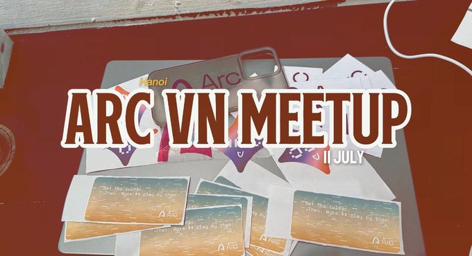 A red surface displays various printed materials and keychains for an 'ARC VN MEETUP' event scheduled for July 11, with cards and merchandise bearing the 'Arc' logo scattered on the table.
