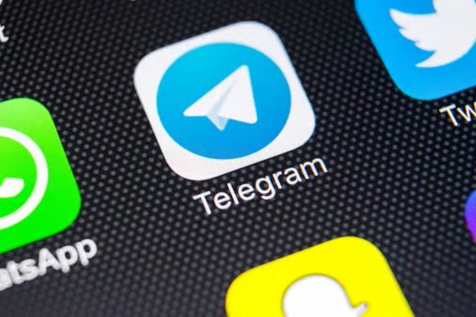 Close-up of a smartphone screen displaying the Telegram app icon alongside WhatsApp and Twitter icons.