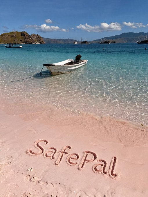 A tropical beach scene with turquoise water, a small anchored boat, and the word "SafePal" written in the pink sand.