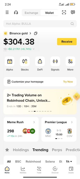 A mobile screenshot of the Binance app showing a Binance gold balance of $304.38 with a +6.74% 1D gain, along with navigation tabs for Alpha, Stocks, DeFi, and Signals.