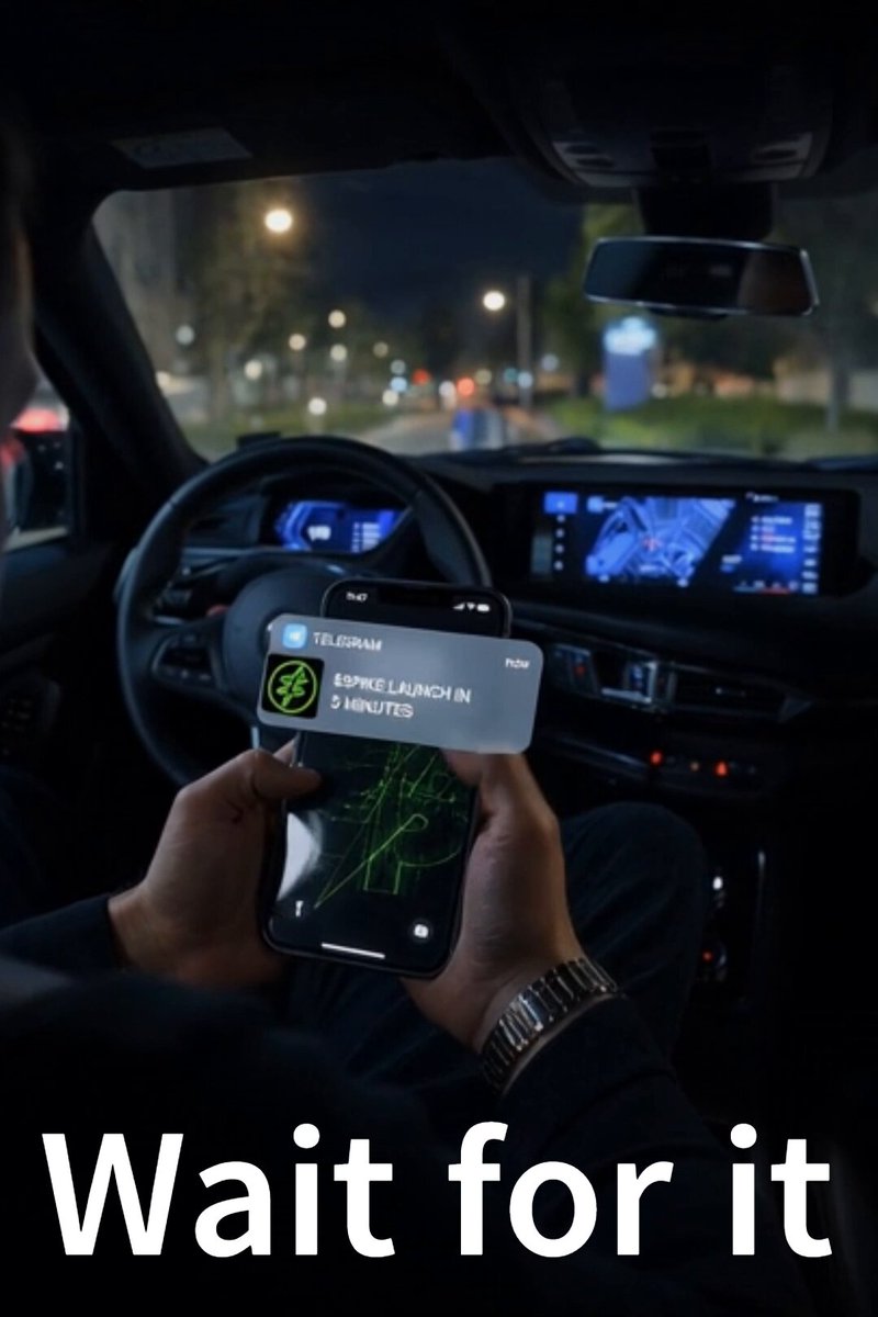 The image shows a person holding up their phone displaying an incoming message or notification, possibly related to a new cryptocurrency called "spikecoin" that has been launched recently. The text of the message reads "WAIT FOR IT".