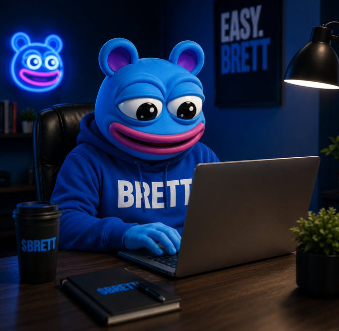 A 3D-rendered blue mascot character wearing a hoodie labeled 'BRETT' sits at a laptop in a dark room with neon signs reading 'EASY. BRETT' and '$BRETT' on a nearby coffee cup.