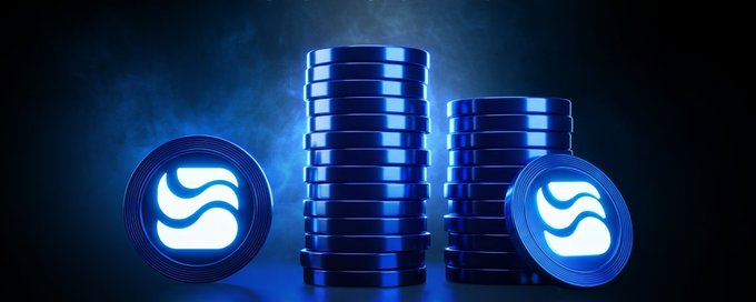 A digital graphic showing stacks of blue coins with a glowing 'S' logo, set against a smoky blue background, likely representing a cryptocurrency.