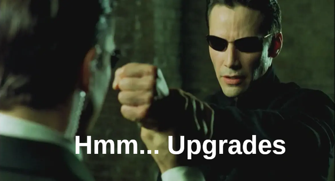The image features two men dressed in suits with sunglasses, one of whom is holding up his fist while the other has his hand resting on his hip. The caption below them reads "hmmm...upgrades", which seems to be a reference to the movie "Yearn". The text suggests that Yearn does not use upgradeable proxies and prioritizes user security over convenience, as upgrades can make it easier for malicious actors to exploit vulnerabilities in their system.