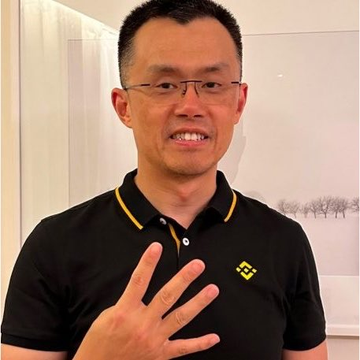 A man in a black polo shirt with a Binance logo gestures while speaking, accompanied by a quote attributed to CZ (Changpeng Zhao) about Giggle Academy selling donated tokens for BNB to fund free education and his interest in meme coins. The image appears to be a screenshot of CZ making an announcement related to the post.