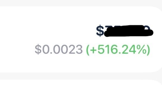 A cryptocurrency price display showing $0.0023 with a +516.24% gain in green, with the token name partially redacted.