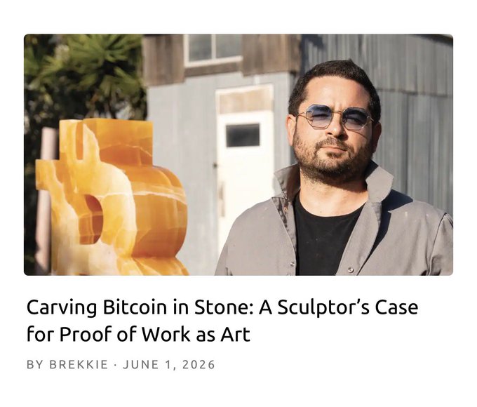 The image features a man wearing sunglasses, standing next to a sculpture made from stone. The text above him reads "Carving Bitcoin in Stone: A Sculptor's Case", which suggests that he might be involved in creating sculptures using Bitcoin as a medium or inspiration for his work.