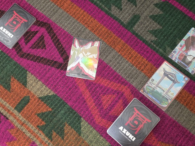 The image shows a pink and green striped rug with four playing cards scattered across it, including two anime-themed cards. The text "Best way to survive for market crash" is written below the cards, which suggests that they are related to a game or strategy involving these cards.