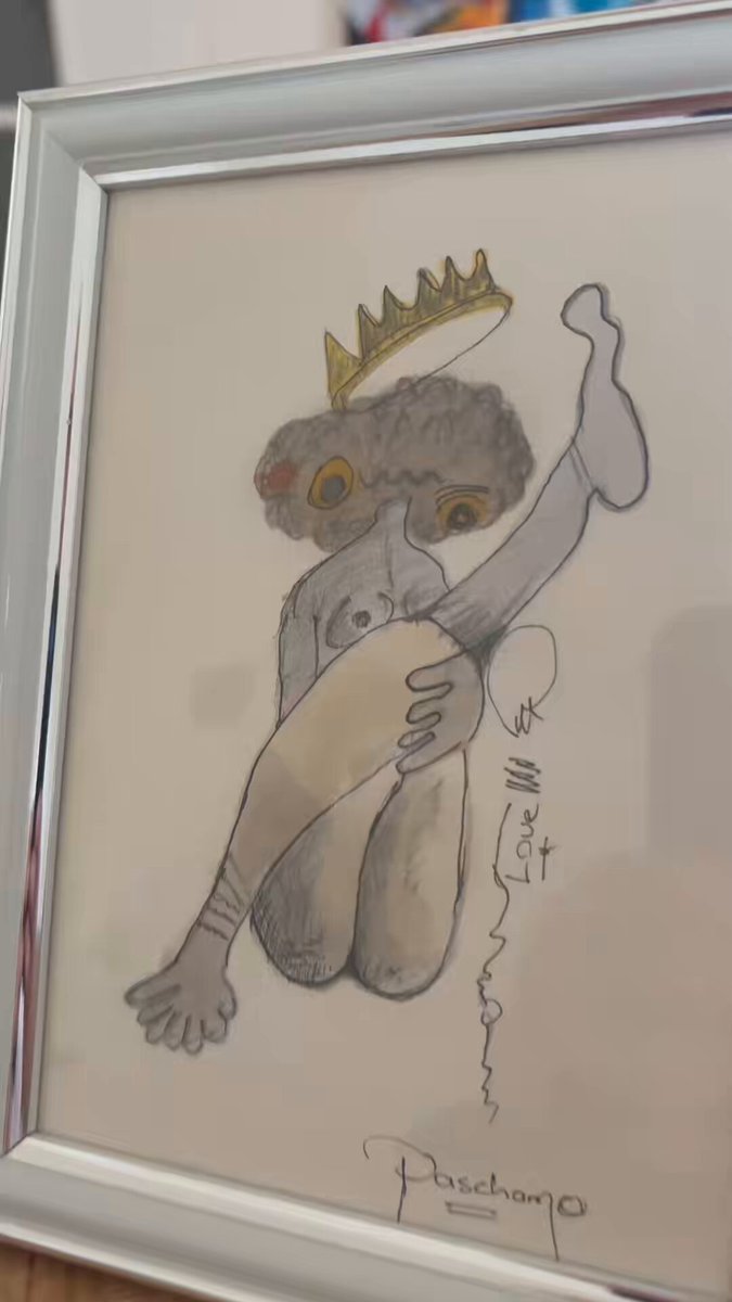The image features a hand-drawn sketch of a person with their legs crossed, wearing a crown. The sketch is framed within a white border and signed by an artist named "Paschano" at the bottom right corner. The sketch appears to be a part of a collection or a series of drawings, as indicated by the text in the image that reads "Check out the doodle collection. Hand drawn sketches from my sketchbook. This one is special to me."