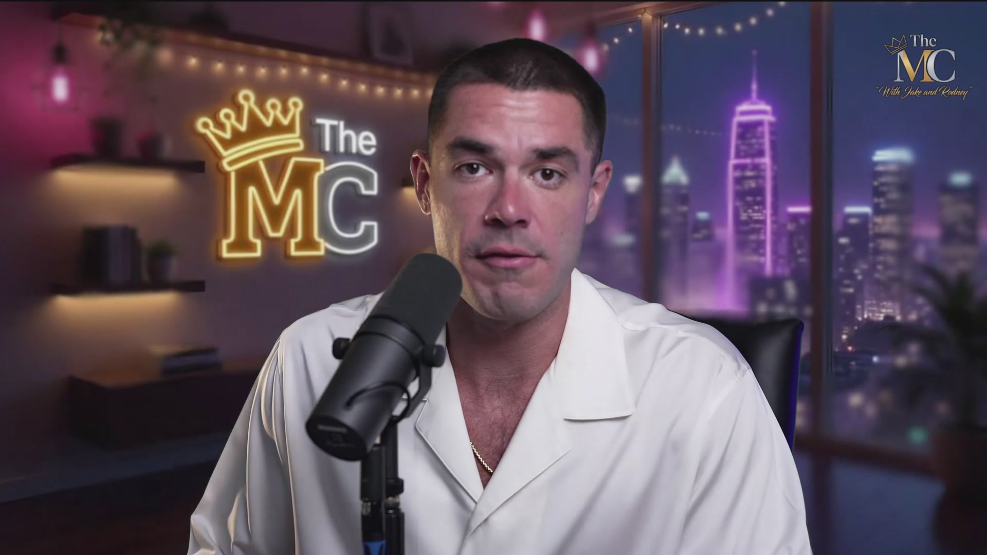 The image features a man wearing a white shirt, standing behind a microphone with his face displayed on a television screen or computer monitor. The background of the image shows a city skyline at night, which appears to be illuminated by neon lights. The caption "Was $69M The Bottom For $TROLL!" is written in black text above and below the man's head, indicating that he has been featured in an article about him.