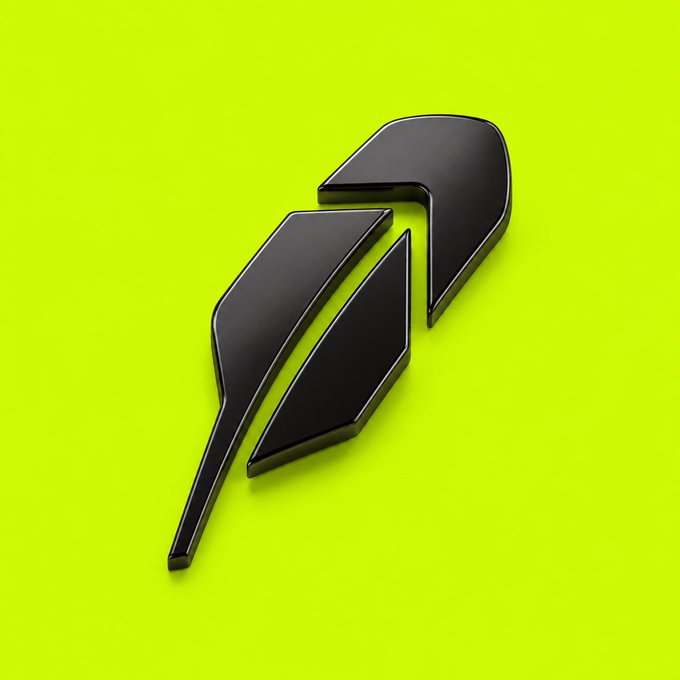 A sleek, stylized black feather emblem rendered in 3D against a bright neon yellow background. The minimalist icon likely represents a cryptocurrency project logo, aligning with the post's mention of underrated Robinhood Crypto projects to watch.