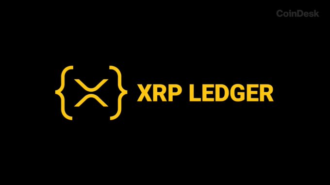 The image displays the XRP Ledger logo in gold against a black background, with "CoinDesk" watermarked in the top right corner. The logo relates to the accompanying post about the XRP Ledger's bug fix and validator support update, branding the news coverage from CoinDesk.