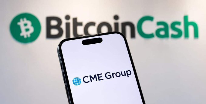 A smartphone displaying the CME Group logo in front of a Bitcoin Cash logo backdrop.