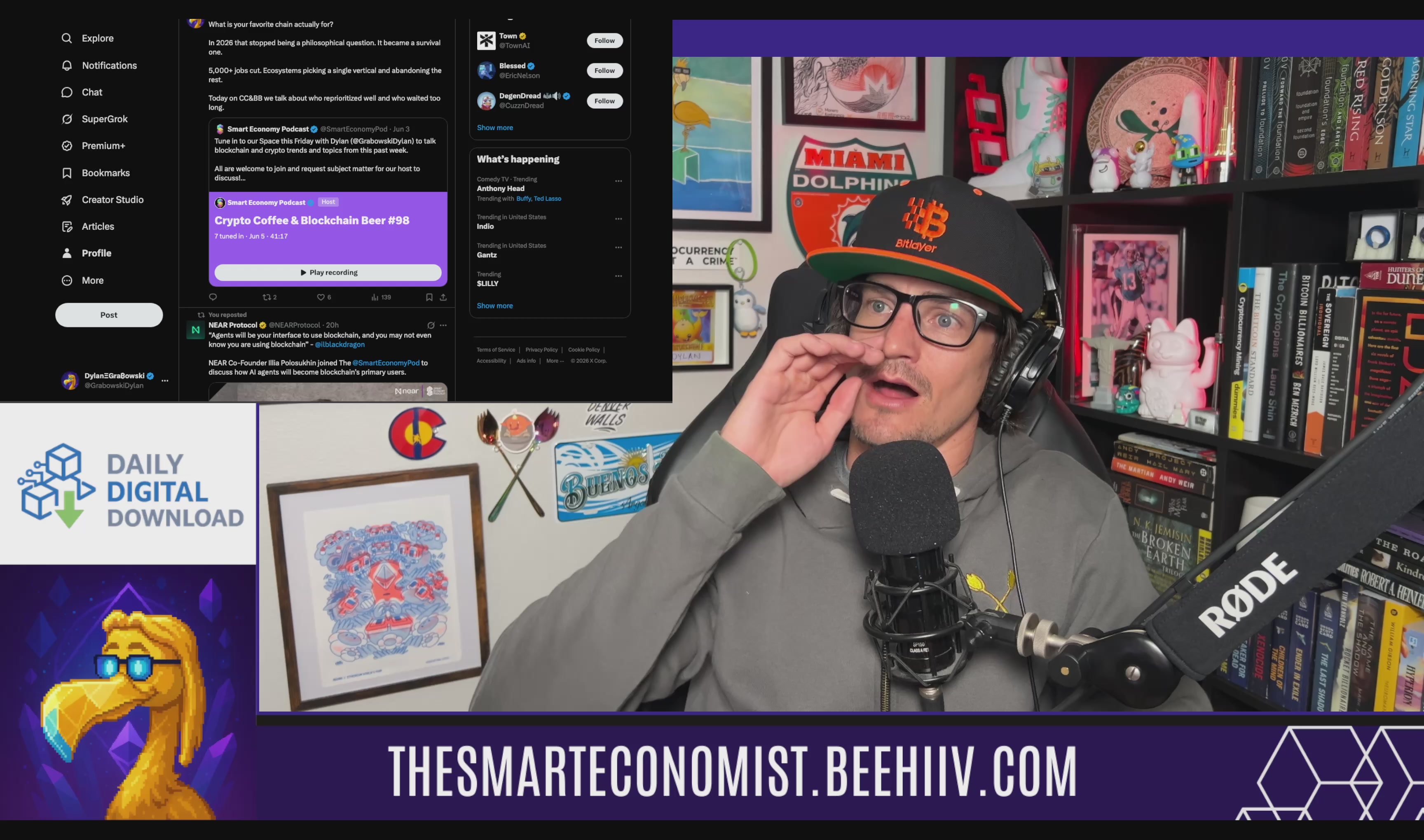 The image shows a man wearing glasses, talking into a microphone while sitting behind a desk with a computer screen displaying a message about a tokenized deposit network for H1 2027. The background features a bookshelf filled with various books.