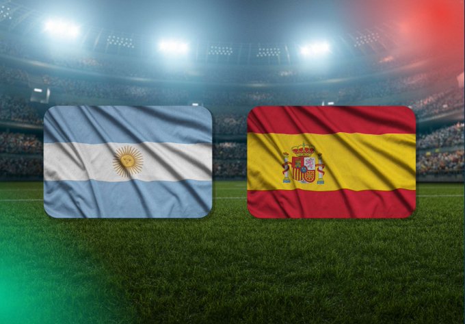 Two national flags—Argentina's light blue and white banner with the Sun of May and Spain's red and yellow striped flag with its coat of arms—are displayed side by side on a soccer pitch inside a lit stadium, visually representing a matchup between the two countries. The post's call to "predict the score" plays off this football imagery, inviting followers to guess the outcome of an Argentina vs. Spain match instead of forecasting Bitcoin's price.