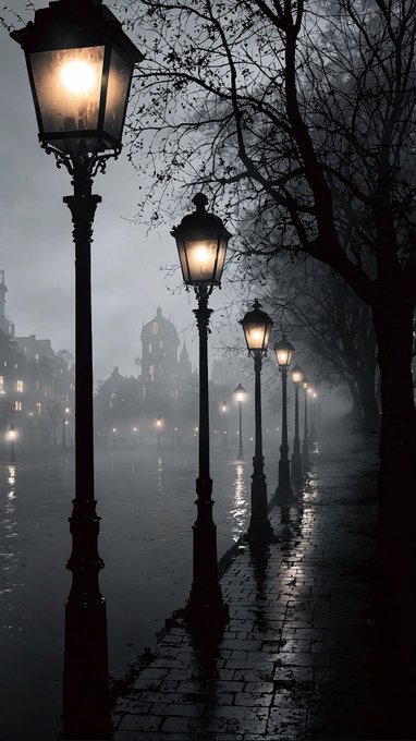 An atmospheric, misty street scene at night featuring a row of illuminated vintage lampposts reflecting on a wet cobblestone pavement.