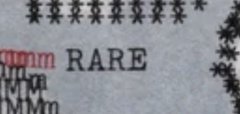 A close-up of a textured gray fabric with star patterns and the word 'RARE' printed in black capital letters.