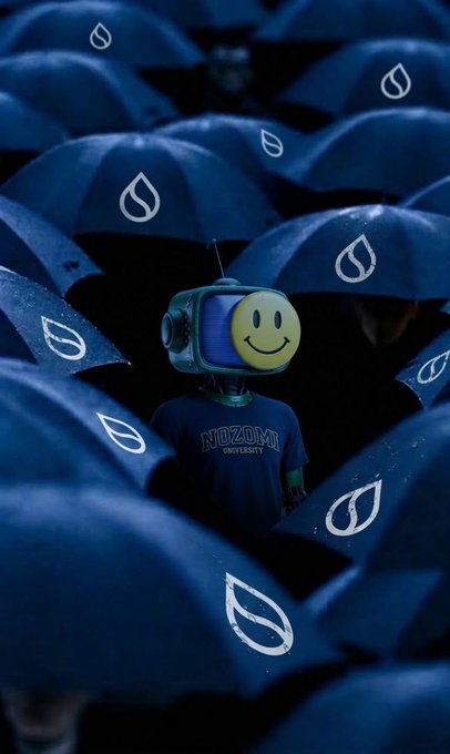 An artistic image shows a robot-like figure with a TV screen head displaying a smiley face, wearing a 'NOZOMI UNIVERSITY' shirt, surrounded by dark blue umbrellas with white droplet logos.