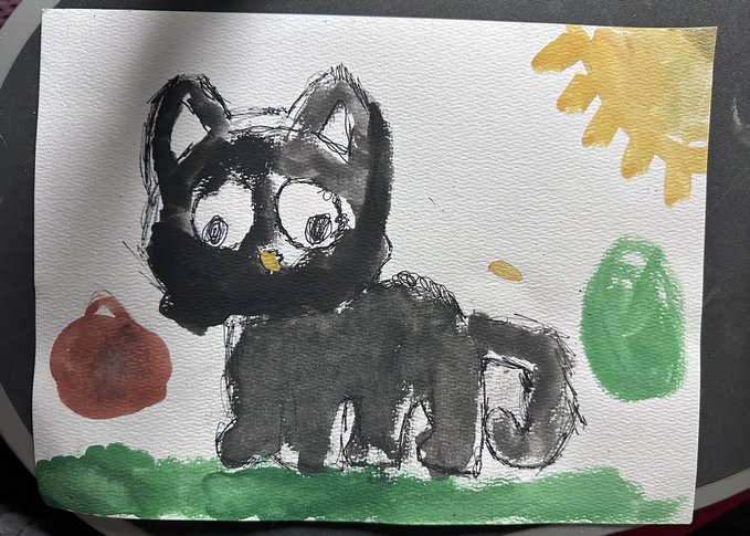A watercolor and ink painting of a black cat with large eyes standing on green grass, surrounded by red, yellow, and green painted shapes.