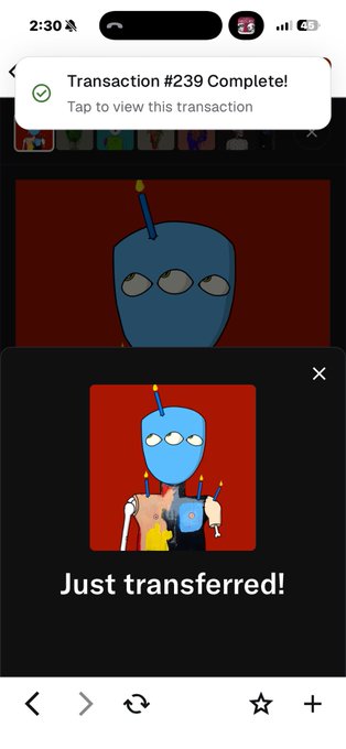 A mobile phone screenshot showing a transaction notification: 'Transaction #239 Complete! Tap to view this transaction' above an NFT image labeled 'Just transferred!' depicting a blue character with a red background.