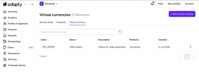The image shows the Adapty dashboard displaying the Virtual currencies page under the "Recipes" project, featuring a token named "VID_TOKENS" (Video tokens) used across 2 products and created on 21 Jul 2026. This visual demonstrates Adapty's new virtual currency feature, which allows developers—especially those running AI apps and short dramas—to easily manage their coin and credit systems in one place.
