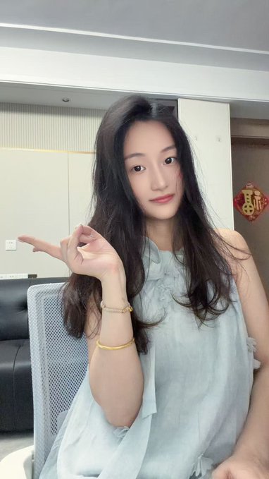 A young woman with long dark hair, wearing a light blue halter top and gold bracelets, poses with a peace sign while seated in what appears to be a living room setting.

The image doesn't visually relate to the post's content about trading levels, shorting calls, or Trump—this appears to be a stock photo or unrelated personal photo rather than something connected to the financial commentary.