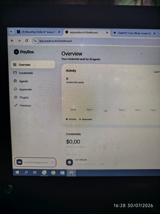 A photograph of a laptop screen displaying the PayBox dashboard at app.paybox.sh, showing an Overview section with '6 events this week' and a Wallet section showing a balance of '$0.00 sol-default', timestamped 16:28 30/07/2026.